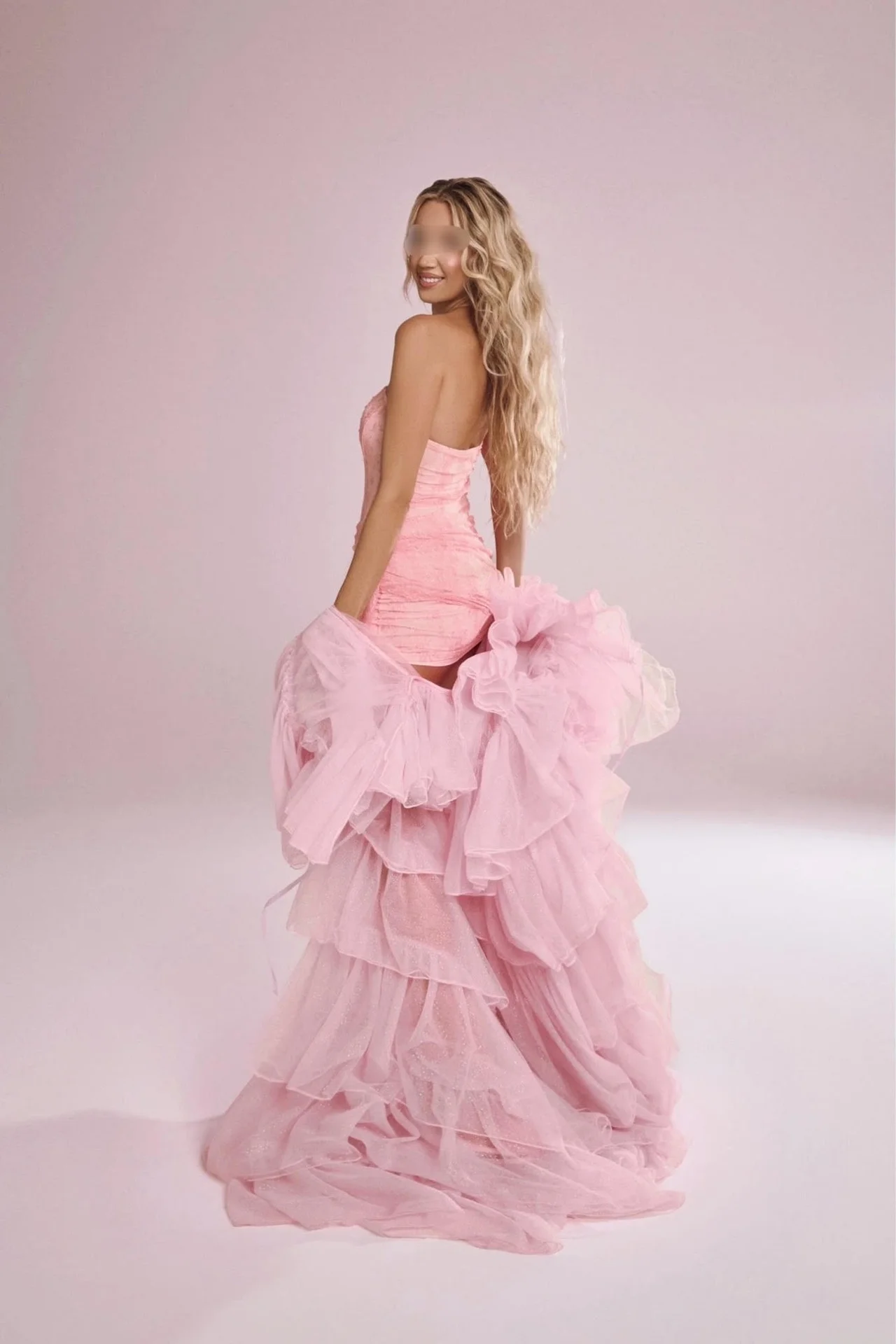 Woman in a pink mini dress and voluminous ruffled skirt