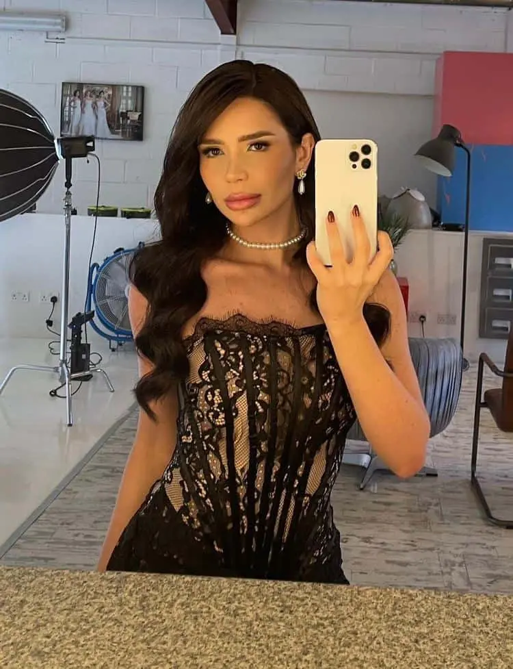 Woman taking selfie in black lace dress
