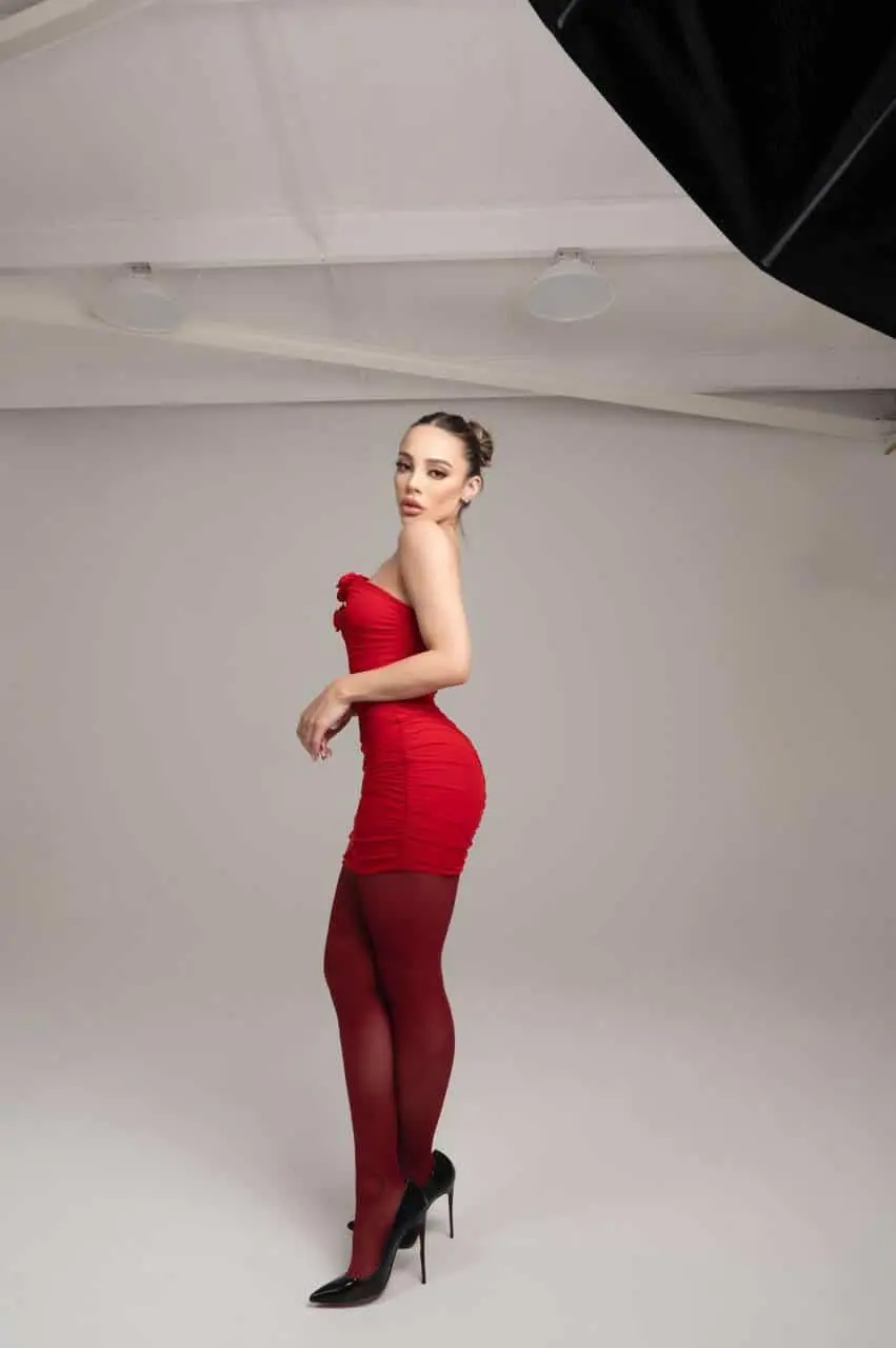 Woman in red dress posing in studio