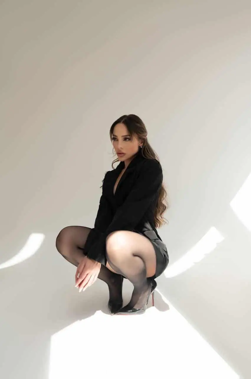 Woman in black outfit crouching