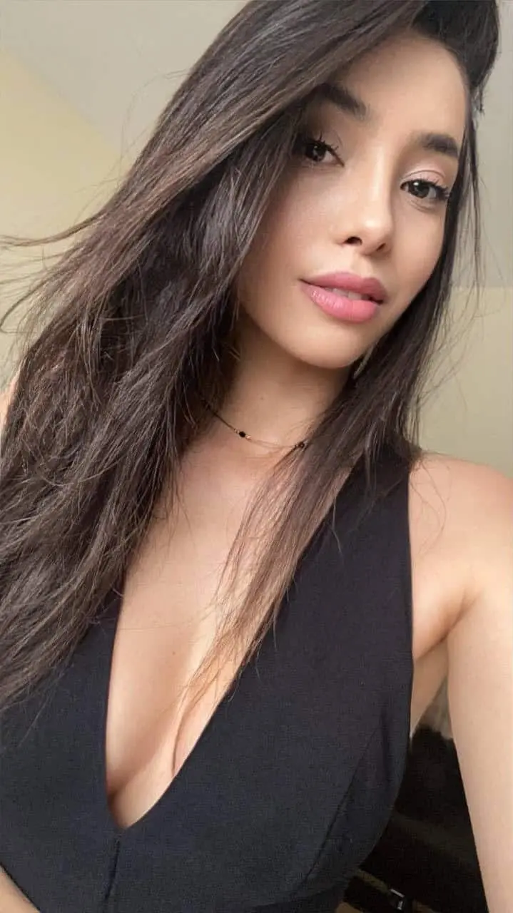 Woman with long hair in black top.