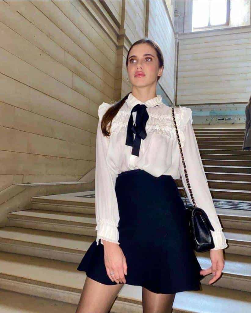 elite escort aprilina3 Woman in elegant outfit on staircase