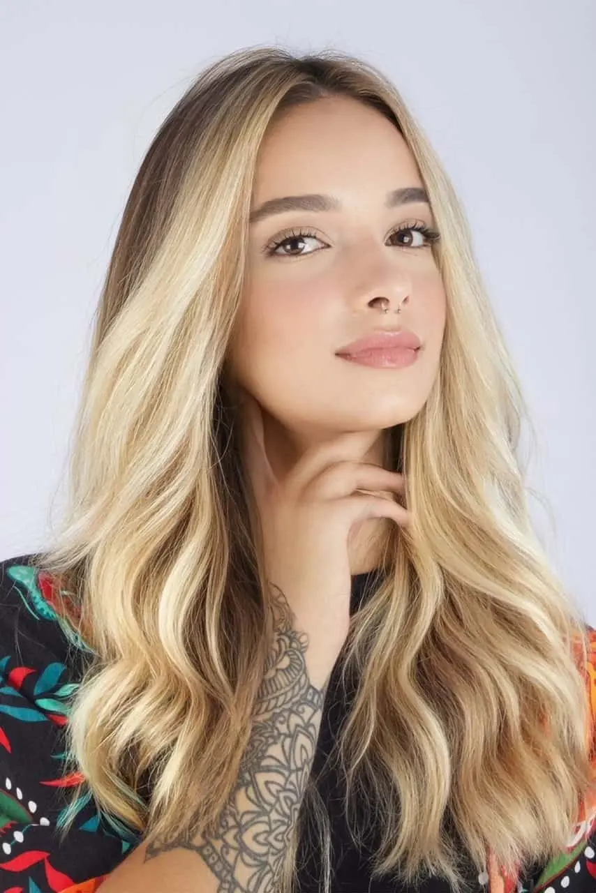 Woman with blonde hair and tattooed hand