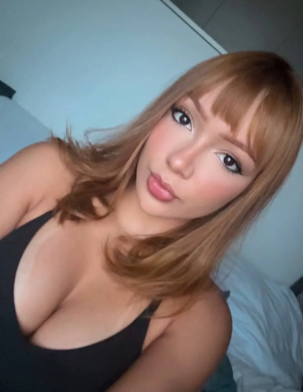 Woman with ginger hair and fringe wearing a black top