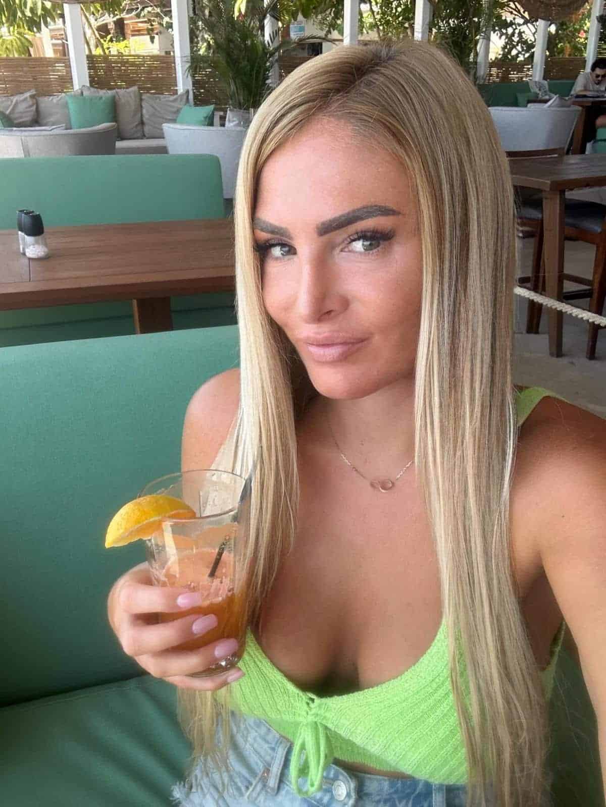Woman with drink in cafe.