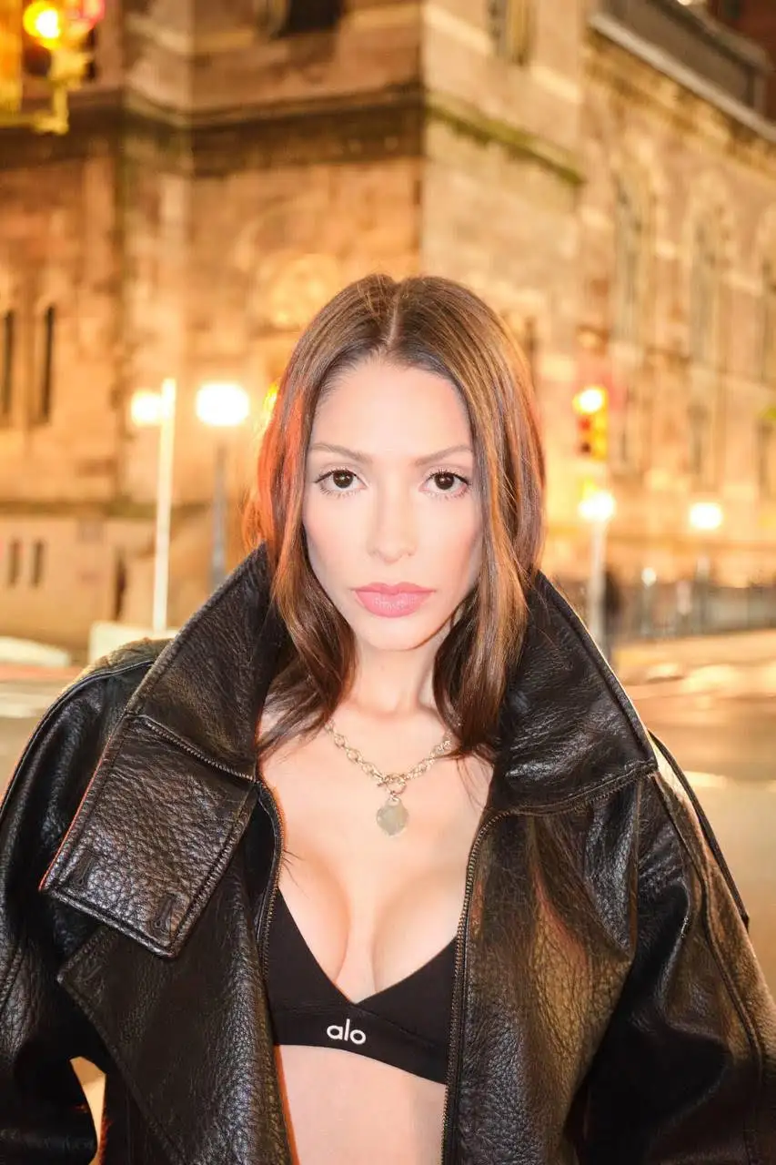 Woman in a black leather jacket and alo sports bra