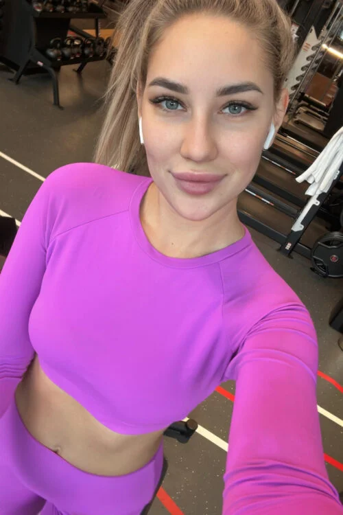 A woman in a purple workout set at the gym.