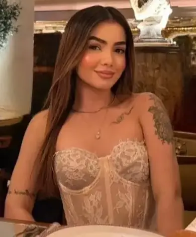 A woman in a lace corset at an elegant restaurant