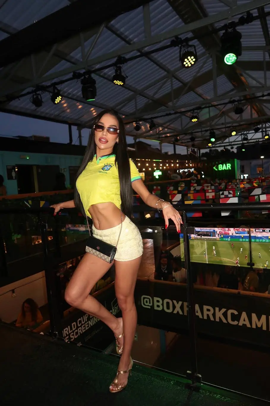 Woman in a cropped Brazil football jersey at Boxpark.