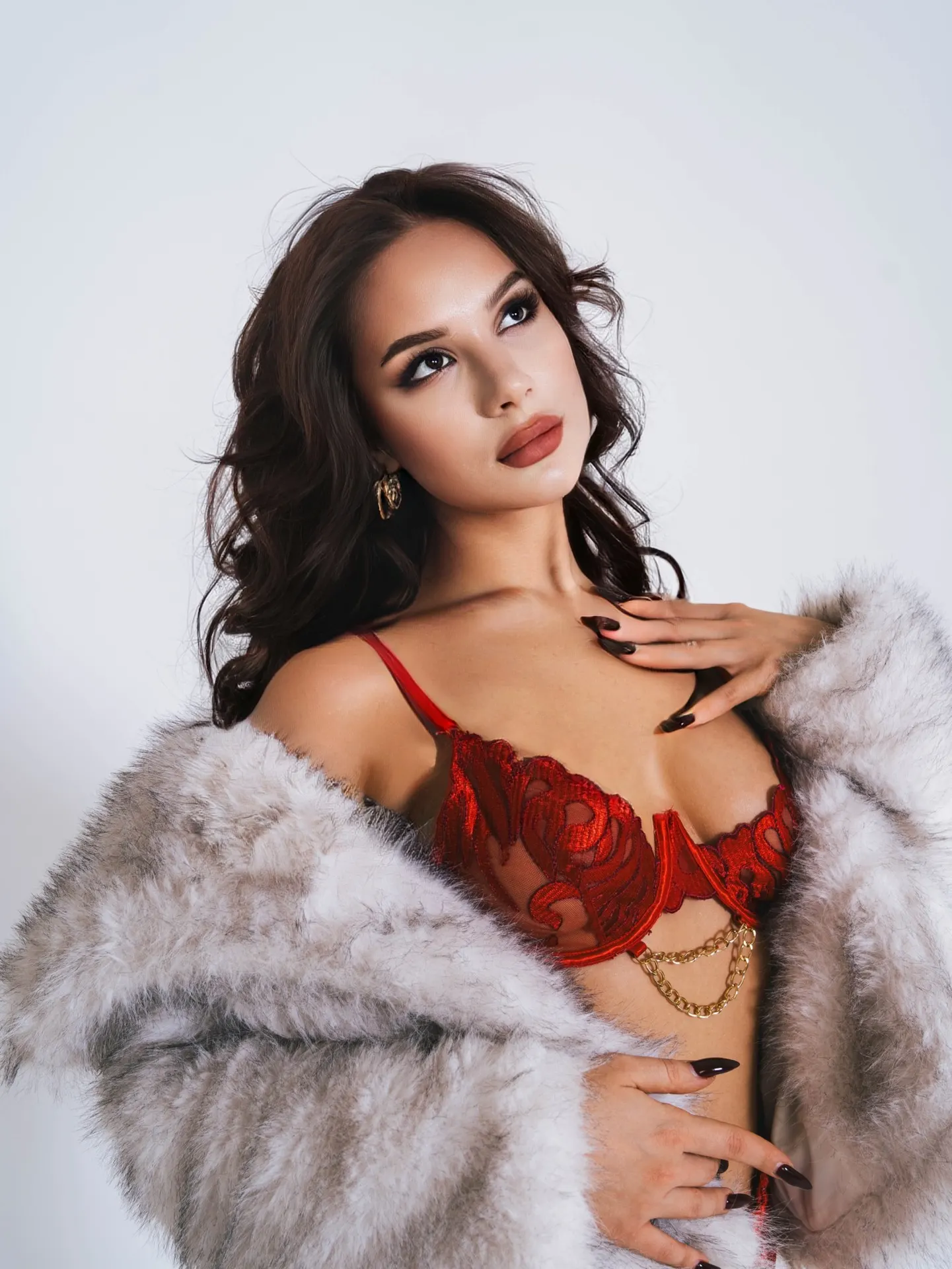 Woman in red lace bra and white faux fur coat