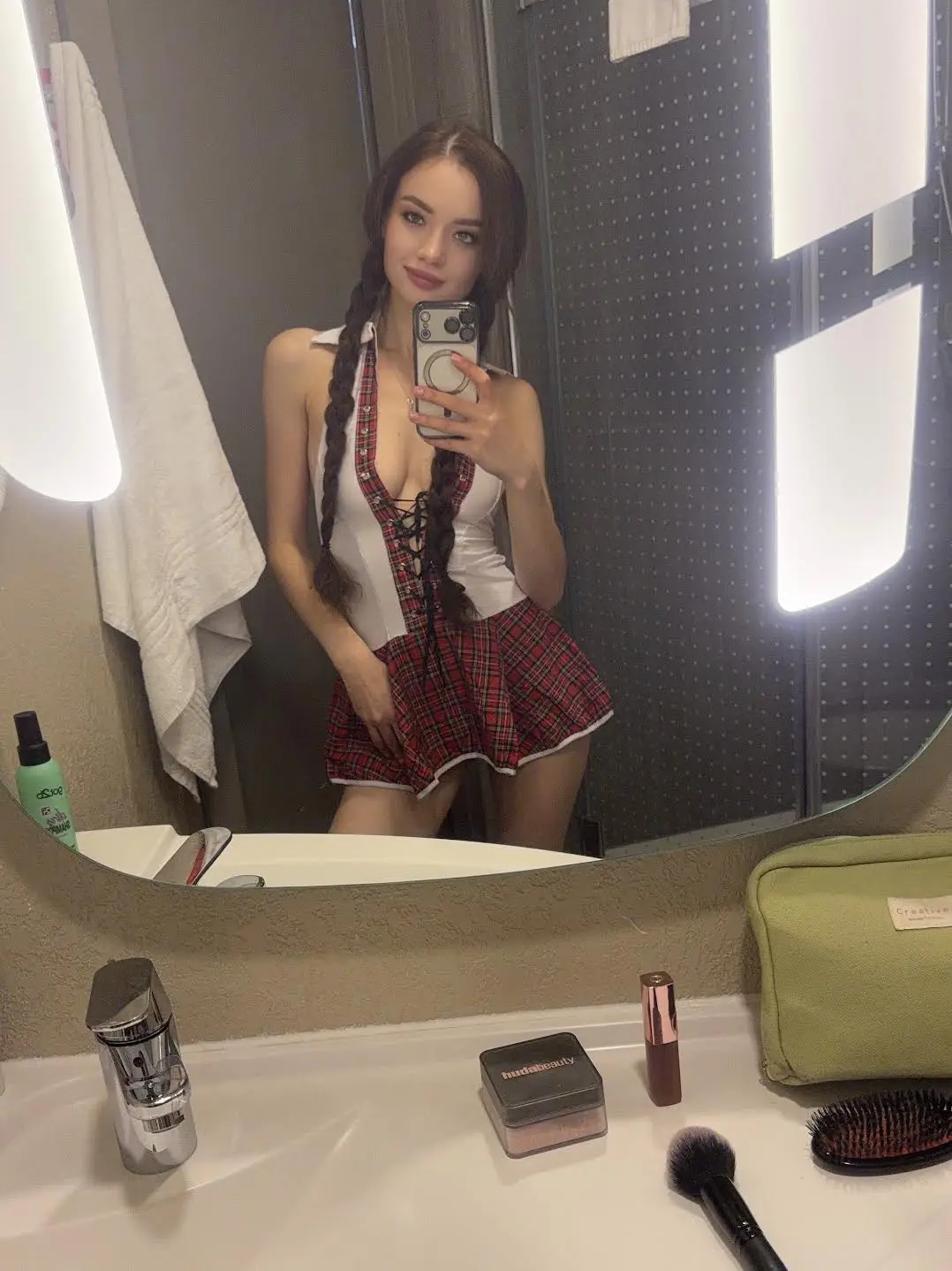 Mirror selfie of woman wearing a tartan schoolgirl costume.