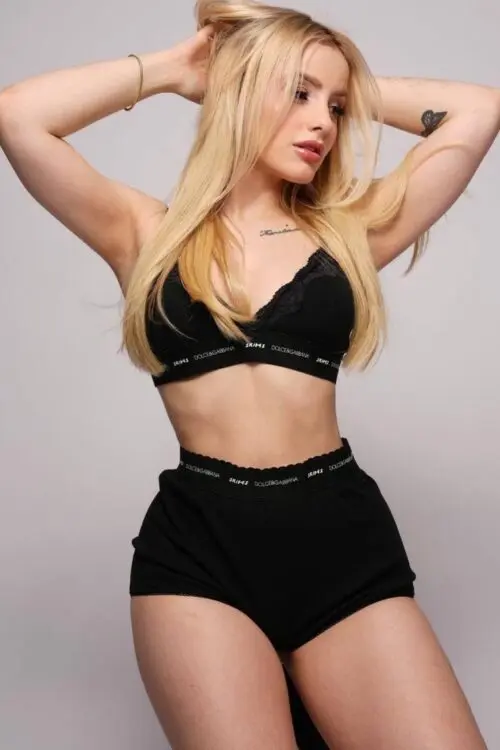 Woman in black SKIMS x Dolce & Gabbana lingerie set.