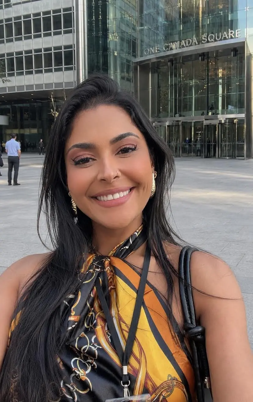 Smiling woman in front of One Canada Square building.