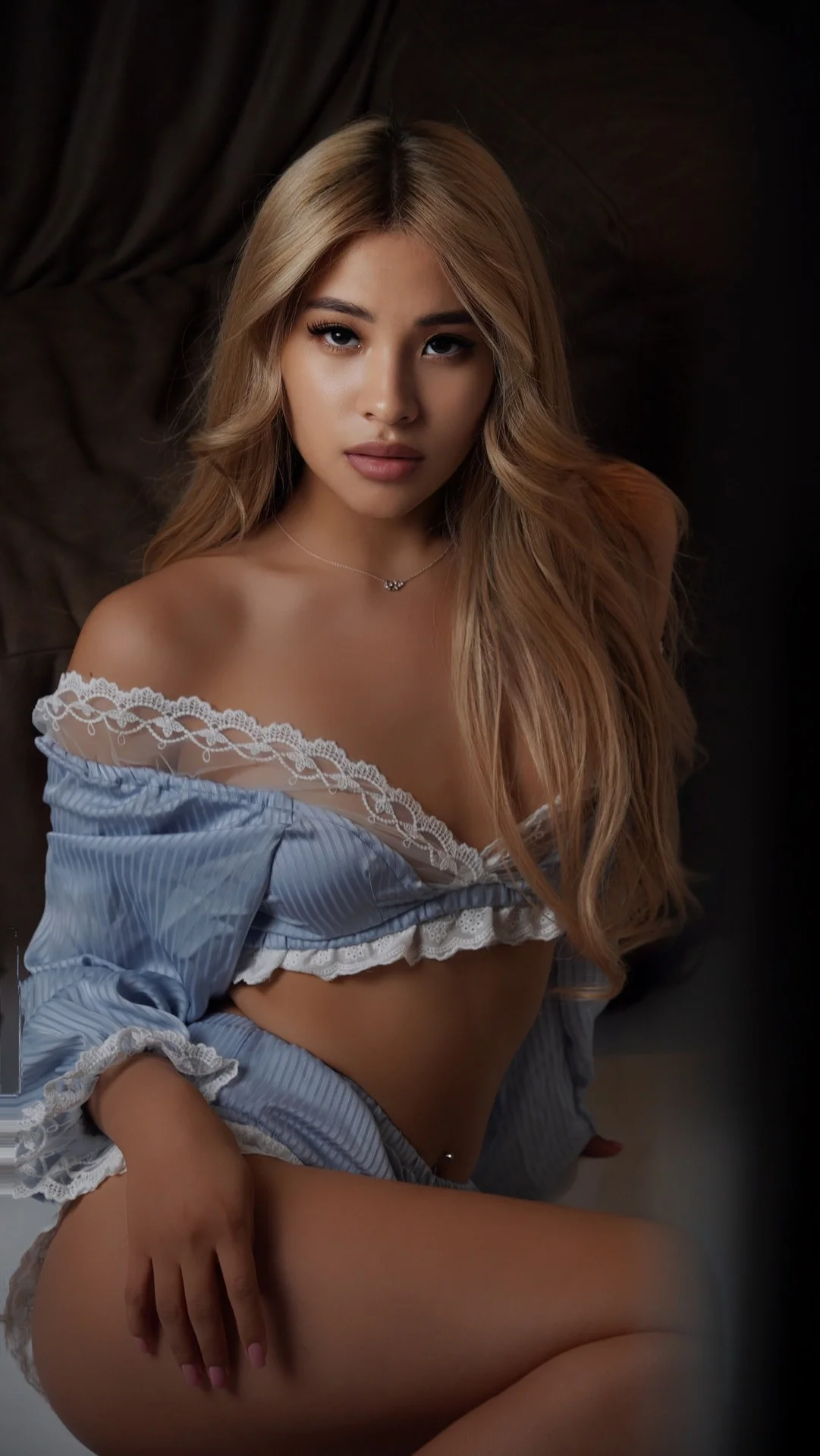 Blonde woman in a light blue, lace-trimmed lingerie set.