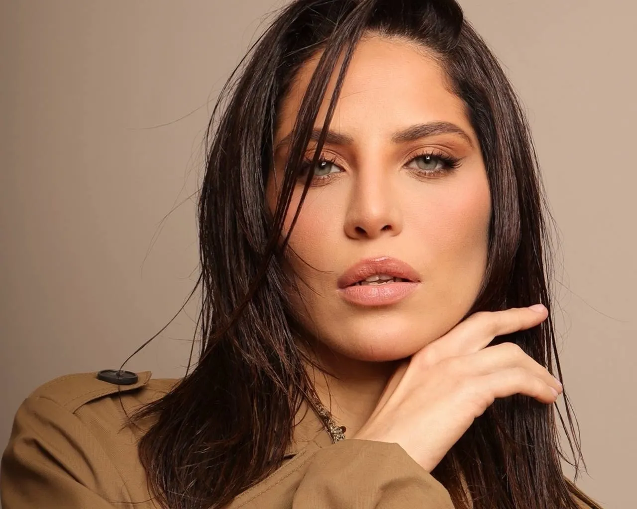 Portrait of a woman with dark hair and light eyes.