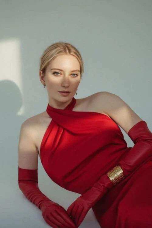 Blonde woman in red halter dress and red leather gloves
